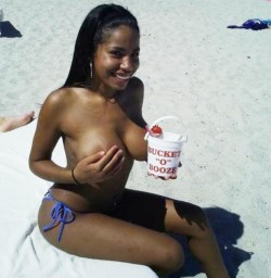 Ebony smiling lady in white sanded beach