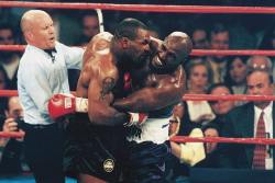 siphotos:  Mike Tyson bites the ear of Evander Holyfield as referee Mills Lane tries to separate the two during their heavyweight title fight on June 28, 1997 at the MGM Grand Garden Arena in Las Vegas. Tyson was disqualified from the match and lost his