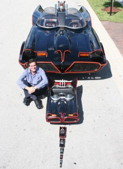 Sergio Goldvarg poses with a small portion of his collection of Batmobiles. The full size one is a custom-built replica of the one used in the original 1966 TV series starring Adam West.