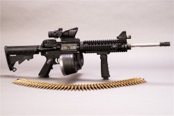 gunrunnerhell:  Custom A Spikes Tactical AR-15 with quite the number of add on accessories. It kind of looks like they started off at the front but gave up (or ran out of money) near the rear of the rifle by keeping the basic grip and stock. The drum