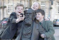 nprbooks:  artjonak:  The great-great-great grandchildren of Dickens take a selfie with him on his 202nd birthday.  Although the author himself hoped to avoid such commemoration, a statue of Charles Dickens was unveiled last week just in time for his