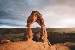 timberphoto:Sat here for a while waiting for the sun to set as the sound of thunder reverberated through the canyon walls and flashes of lightning danced across the sky. All of the sudden the sun broke through the clouds and lit up the arch in golden
