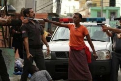   Haitian woman defending her son in the Dominican Republic.  This picture is raw  damn this woman is a strong mother fucking person power to the people  A powerful photo, look at her eyes man   i have so much respect rn