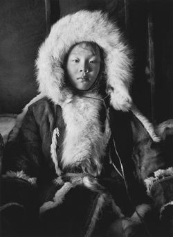 2000-lightyearsfromhome:   This portrait of a young girl illustrates both the beauty of and the importance given by the Nenets to their clothes. Her main coat is made of the inside of reindeer skins, while her hood is made with the fur of blue fox   