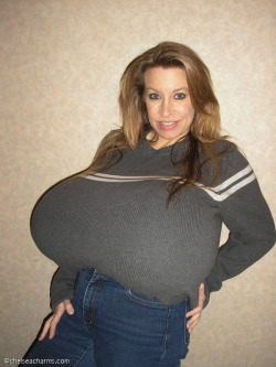 Look at her stretch that baggy sweater into something that shows off her round tits.