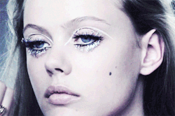deprincessed:  Making-of Magic: Frida Gustavsson has tiny shimmering jewels added on to her doll lashes along with a 60’s inspired sweep of white eyeliner done by makeup artist Lisa Eldridge giving off a sparkly retro vibe in a behind the scenes look