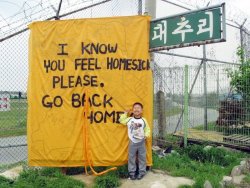 furtho:Banner outside a US military base, Daechu-ri, South Korea (via here)