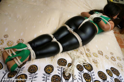 diaryofasexcrazedbbw:  Hannah wanted to spice up the St. Patrick’s Day party by wearing her latex pants and brand new green fuck-me pumps.  She ended up with her hands bound, body roped, and mouth gagged in the hosts master bedroom.  He had green