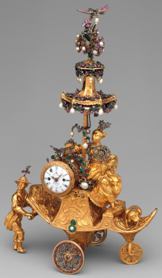 ufansius: Gold automaton in the form of a chariot bearing a clock pushed by a Chinese attendant, set with pearls, diamonds, and paste jewels - James Cox, 1766 When activated the chariot’s wheels turn, the whirligig in the woman’s left hand spins and
