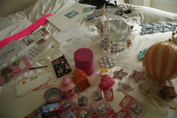 igotosleeptodream: stuff for my room in holland: a drawing from ella, photos of bailey, a matted version of my angel picture and some envelopes to frame, hot air balloon mobile, floral magnets, mini lanterns, feather tree that madeline made me, mini vodoo