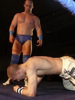 piledriveu:  look at the contempt in his eyes, he wants to fuckin destroy the smaller toned dude, totally just demolish him as he towers over him!  Sexy Heel, Robbie Dynamite. 