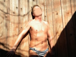 speedotwink:  Against the wall at the hottub in the sunshine in my tiny wet unlined striped sailor spandex speedo bikini with buttons 