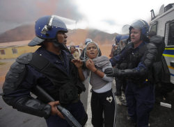The Guardian,	Wednesday 22 September 2010 South African police arrest a suspected rioter in Hout Bay, Cape Town. Forty people were injured in clashes at the township.