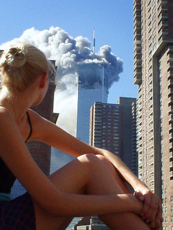 lovelies-t:  alexisbelon:  Australian model caught distracted during a photo shoot when the first plane hit tower 1. What an epic photo.  wow the fact this was captured. you can’t see her face but i would love to know what her reaction was. this picture