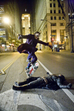 sufferthisuniverse:    Heath Ledger as the Joker skate boarding over Christian Bale as Batman while they take a break on the set of The Dark Knight.  
