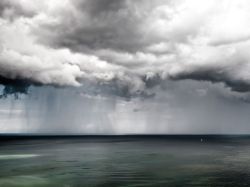 nationalgeographicmagazine:  Sailboat at Sea, Germany Photograph by Patrick LieninWhile hiking at Jasmund National Park in northwest Germany, a rainstorm passed by and created a stunning scene! The sea was completely flat and the only thing out there