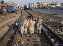 mariaarassiee:  Children pose for a photograph as they collect recyclable materials along a railway track near a slum in Karachi. 