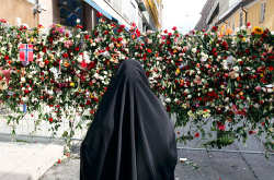 A Muslim woman stands in front of a sea of flowers placed outside Oslo Cathedral July 26, 2011.Read more: http://www.time.com/time/photogallery/0,29307,2084743,00.html#ixzz1TiBtios0