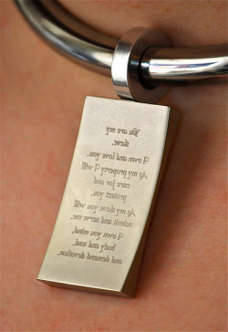  wyredslave: Message in the Mirror on Flickr. Close up of an engraved tag hung from a slaves collar. The picture is not back to front; the engraving has been done in reverse so the slave can read the message in a mirror, as she cannot remove the collar