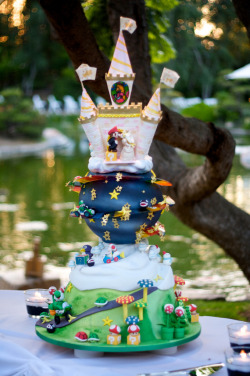 it8bit:  Super Mario Kart Cake  - by letthemeatcake For flickr user M.A.L.’s wedding, this special gaming cake is 100% edible. The planet design is inspired by Super Mario Galaxy and features a Rainbow Road track (which Luigi is racing on) wrapped