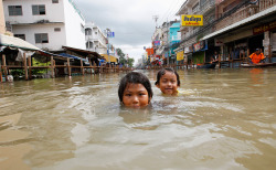 reblololo:  Worst Flooding in Decades Swamps Thailand - Alan Taylor - In Focus - The Atlantic Children play in a flooded street in Sena district, Ayutthaya province, about 80 km (50 miles) north of Bangkok, on September 12, 2011. Monsoon rains, storms,