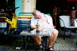 Drunk man asleep in Saigon.