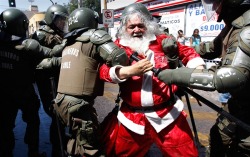 thepoliticalnotebook:  Picture of the Day. Santiago, Chile. Santa Claus is arrested during a student protest in Chile demanding reform to the public education system. Photo Credit: Ivan Alvarado/Reuters. Via. View more Picture of the Day posts. Submit a