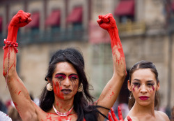 jamiesinverguenza:  [Image: a photograph of two young brown-skinned women who have red paint on their faces and hangs. The women on the left is raising both of her fists in the air.]deafmuslimpunx:pretendpagan:Trans* activists in Mexico City, protesting