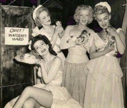 Rose La Rose and a group of other showgirls pose for a publicity photo with newborn kittens, backstage at Boston&rsquo;s &lsquo;Old Howard&rsquo; Theatre..