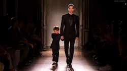 deliriosity:   Brazilian model Alexandre Cunha was paired with a three-year-old moptop to showcase Smalto’s matching child-sized and adult tuxedos. Unfortunately, while the pressure of performing didn’t faze the buff Brazilian, his partner broke down
