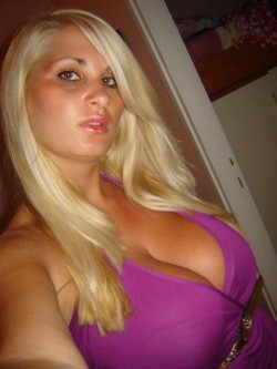 Busty blonde in a purple dress