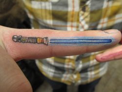 fuckyeahtattoos:  These are my tattoos that I got done in January of 2011, in Cedar Rapids, Iowa, by Bryan Merck of Wildside Tattoo.  On the right index finger is Obi-Wan Kenobi’s blue lightsaber, and on the left index is Darth Vader’s.  Both from