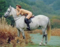 Nude horse back riding.