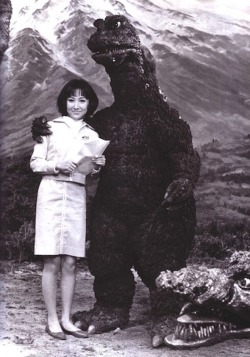 Godzilla poses with a fan.