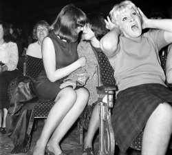 parliament-of-owlets:   A couple only have eyes for each other at a Beatles concert in Wigan, 13 October 1964.  #i don’t know what i like more; vintage lesbians or the lady in front going fucking apeshit  