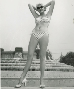 burlyqnell:  Candid photo of all 6’ 8” ( before heels) of Ricki Covette; here, modeling a polka-dot bikini..