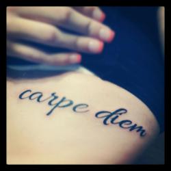 fuckyeahtattoos:  This is actually my first tattoo. “Carpe Diem,” its latin for “Seize the day, putting as little trust into the future.” I met someone this year who I believe I learned that from. I’ve realized that we arnt always handed another