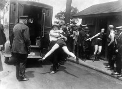 Women being arrested in 1922 for wearing revealing swimming suits.