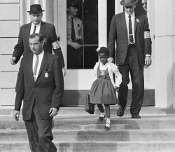 fyeah-history:  Ruby Bridges, the first African-American child to attend an all-white elementary school in the American South, escorted by U.S. Marshals dispatched by President Eisenhower for her safety, 14 November, 1960 