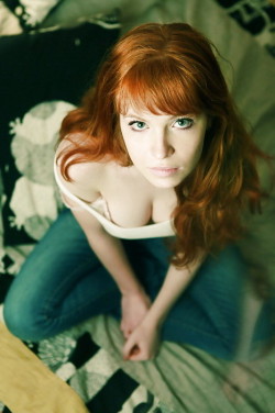 Pretty eyes redhead showing chest.