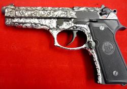 pimpingweapons:  Engraved Beretta 92; the same engraver apparently does hubcaps. I didn’t want to research further.