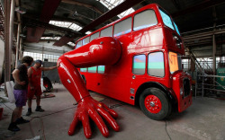 archiemcphee:  Check out this awesome bright red double-decker bus that does push-ups with a pair of giant robot arms! Czech artist David Černý purchased the traditional 1957 London bus in the Netherlands and modified it by attaching two huge muscular
