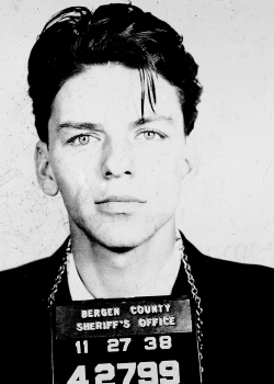 fuckyeahthevoice:  Even in a mug shot it is an astonishing face. The extravagantly sensual lower lip. The intelligence of the pale, wide-set eyes. The greasy hank of hair over the left eyebrow—he could have flicked it out of the way; he chose not to—is
