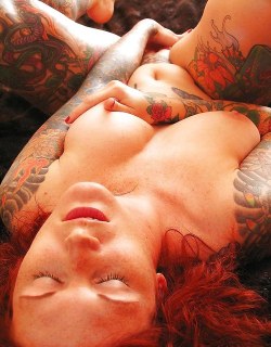 Tattooed redhead touching herself. Hot!