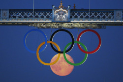  The full moon rises through the Olympic Rings, hanging beneath Tower Bridge, during the London 2012 Olympic Games - August 3, 2012. 
