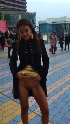 flashingfemales:  Her name is Julie P from voyeurweb bestofexhibition:  Asian showing her pierced pussy in a very busy square!  