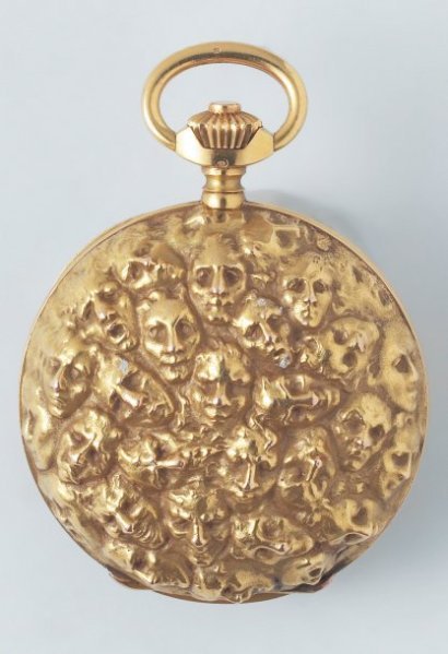 fuckyeahlalique: René Lalique (1860-1945), Pocket watch, c. 1900. Yellow gold, classical watch mechanism. Decorated with masks, after a drawing by Rodin.  Diameter: 5 cm.  