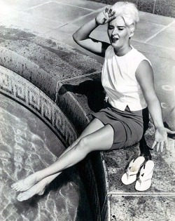 A press photo from October of ‘63 features Tania Dawn cooling her feet during a Los Angeles heat wave.. The photo was used in a newspaper column reporting the early morning arrest of &lsquo;L.A. Dodgers&rsquo; pitcher: Johnny Podres, on a drunk driving