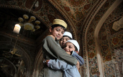 saaraeliisa:  Pakistani children greet each other after offering Eid Al-Fitr prayers at a mosque in Peshawar. 