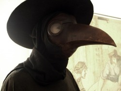 the-creepy-things:  During the plague in the Middle Ages, some doctors wore a primitive form of biohazard suit called “plague suits”. The mask included red glass eyepieces, which were thought to make the wearer impervious to evil. The beak of the